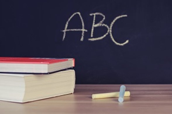Books and ABC written on blackboard